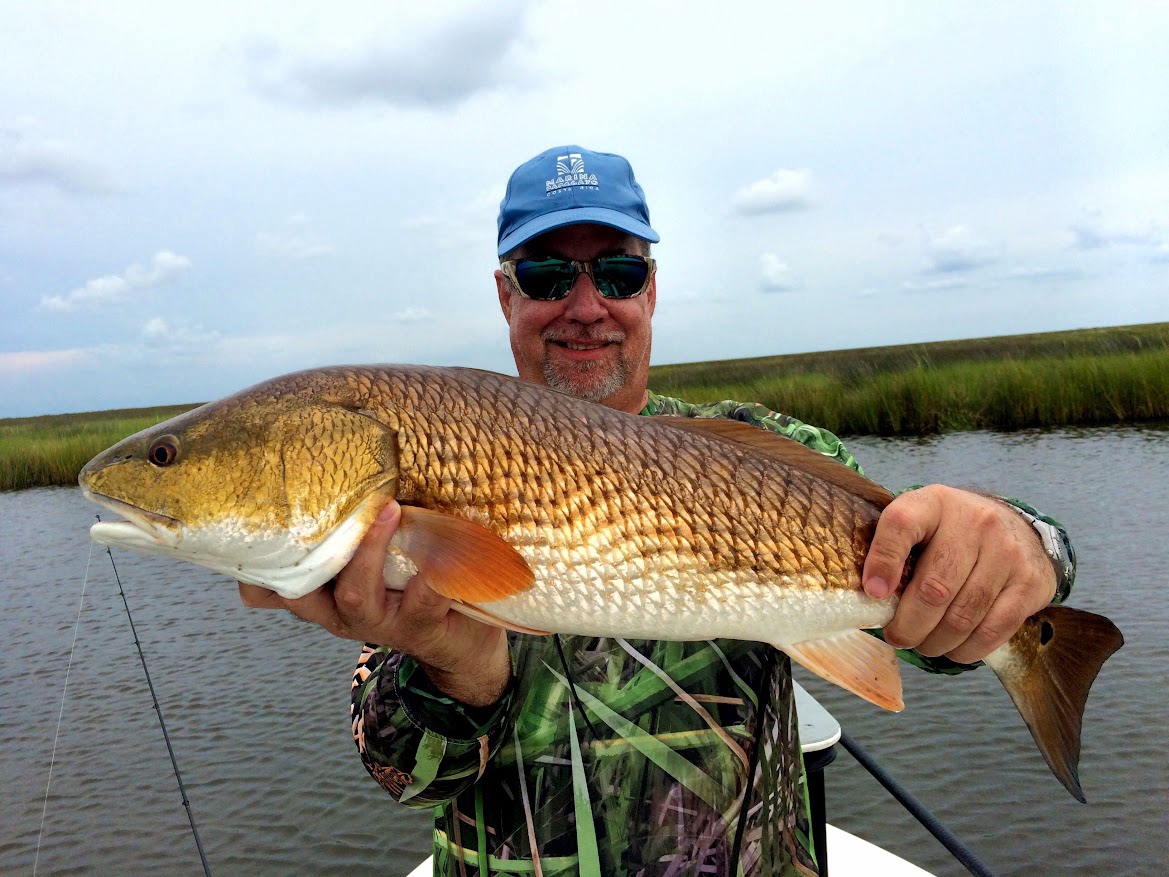 Bruce holding a big redfish in the Louisiana marsh