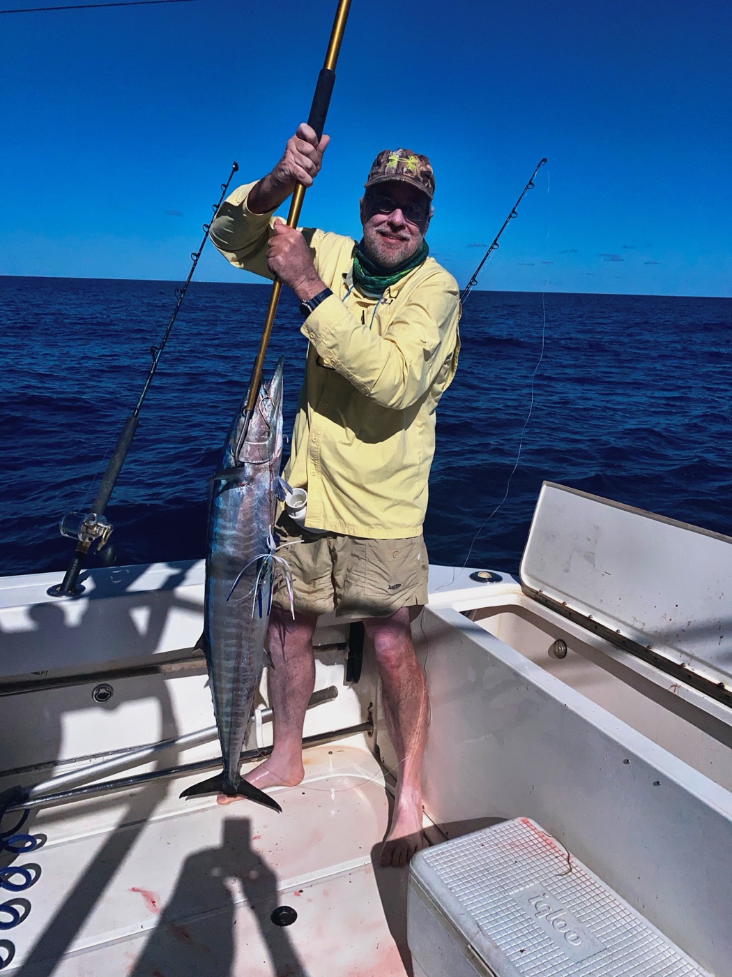Bruce holding a gaffed wahoo on the deck of a boat off Bimini